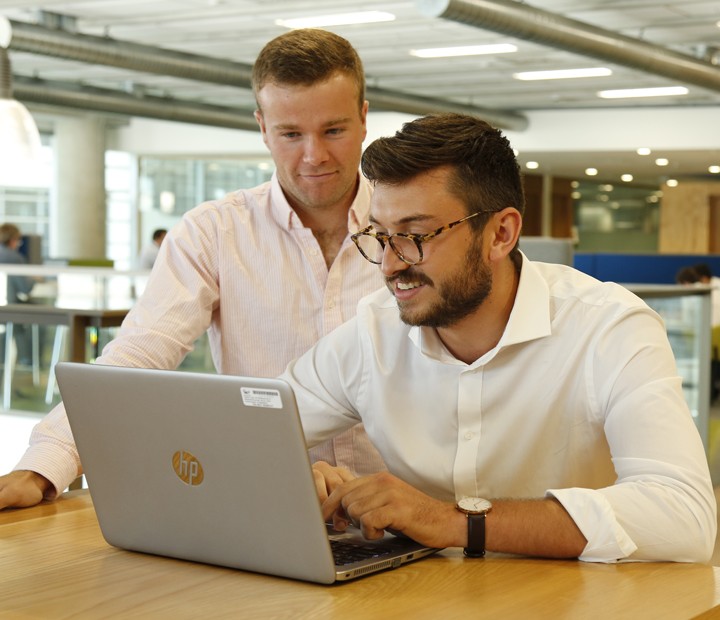 Two men looking at the computer