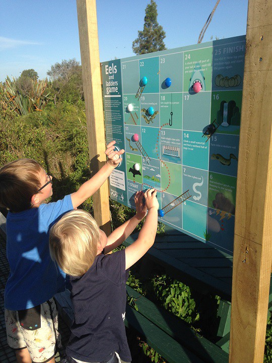 Children playing with Eels and ladders game